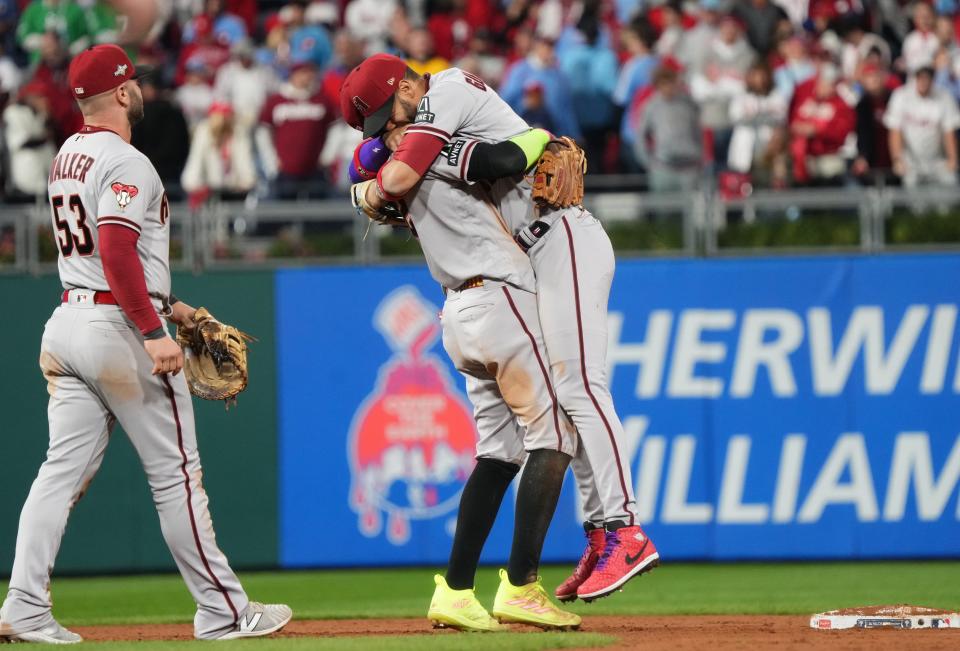 Arizona Diamondbacks teammates Geraldo Perdomo embraces Lourdes Gurriel Jr. as they celebrate their 4-2 win over the Philadelphia Phillies in Game 7 of their NLCS at Citizens Bank Park.