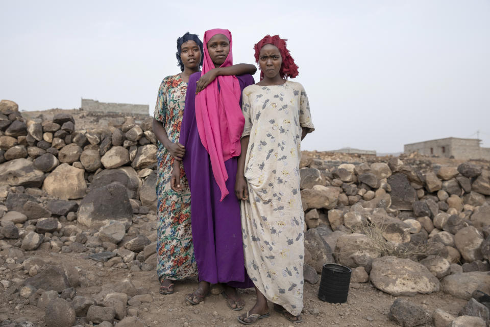 In this July 12, 2019 photo, teenagers, from right, Hamdiya, Ikram, and Safeya, pose for a portrait at a slum where they took shelter after entering the country making it the first stop of their journey, north of the border with Ethiopia, in Dikhil, Djibouti. The 100-mile (120-kilometer) trip across Djibouti can take days. Many migrants end up in the country's capital, also named Djibouti, living in slums and working to earn money for the crossing. Young women often are trapped in prostitution or enslaved as servants. (AP Photo/Nariman El-Mofty)