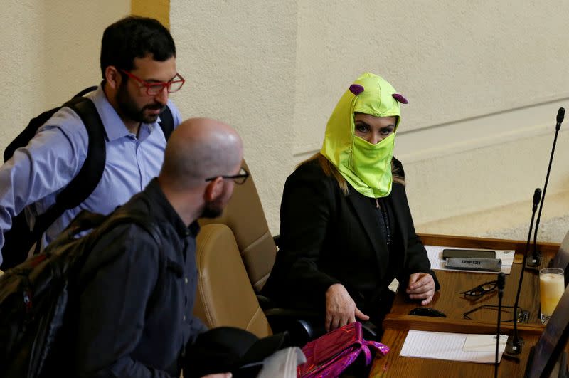 Opposition lawmaker Pamela Jiles is seen hooded during the debate and vote on an impeachment motion against Chile's President Sebastian Pinera, at a session at the congress in Valparaiso