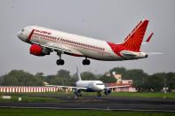 FILE PHOTO: An Air India Airbus A320 aircraft takes off as an IndiGo Airlines aircraft waits for clearance at the Sardar Vallabhbhai Patel International Airport in Ahmedabad