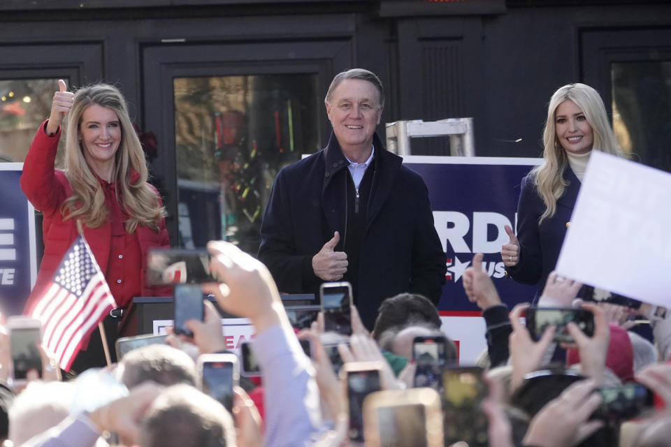 Sen. Kelly Loeffler, R-Ga., left, stands with Sen. David Perdue, R-Ga., and Ivanka Trump, Assistant to the President, during a campaign rally, Monday, Dec. 21, 2020, in Milton, Ga. (AP Photo/John Bazemore)