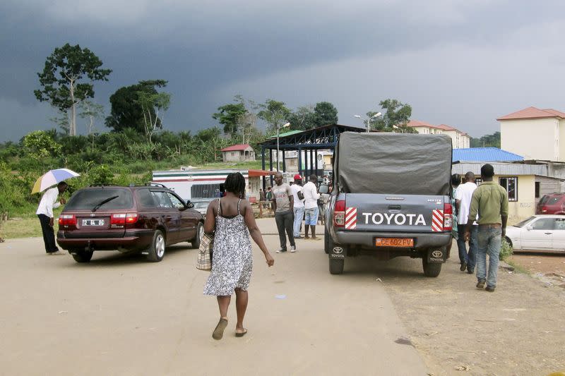 FILE PHOTO: People wait to cross the border into Equatorial Guinea by car and by foot in Kye-Ossi