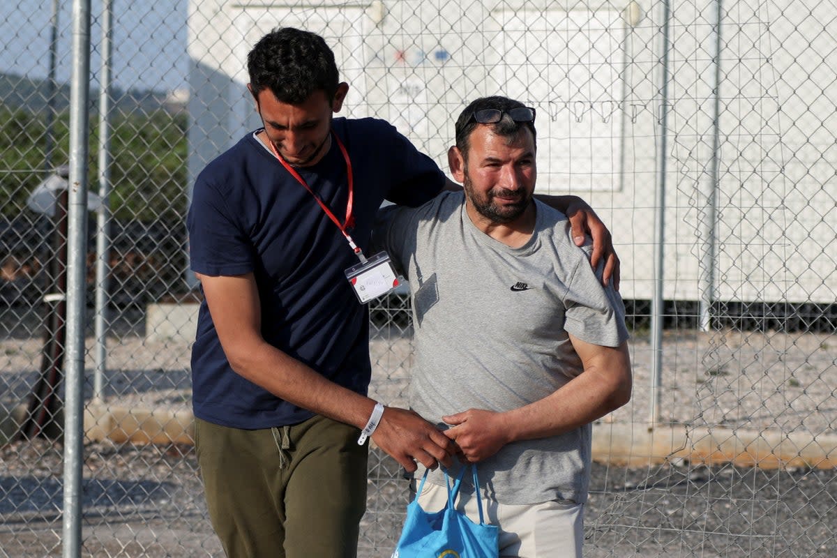Egyptian survivor Atia Al Said, 22 is reunited with his uncle Mohamed El Sayed El-Dadamony Radwan, 54, at a Greek migrant facility (Reuters)