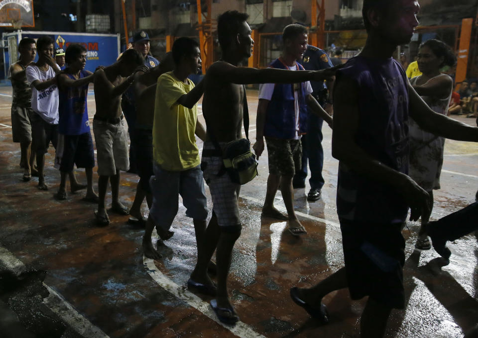 <p>Police round up residents, during a police “One Time Big Time” operation in the continuing “War on Drugs” campaign of President Rodrigo Duterte at slum community of Tondo in Manila, Philippines late Friday, Sept. 30, 2016. (AP Photo/Bullit Marquez) </p>