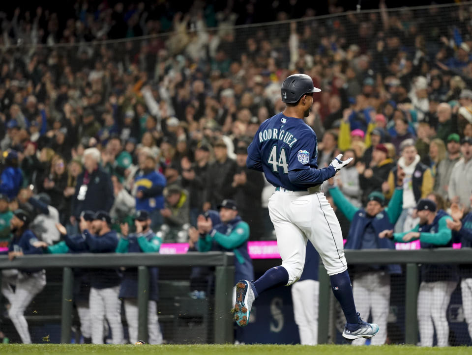 Seattle Mariners' Julio Rodriguez reacts after scoring on a single by Kolten Wong against the Cleveland Guardians during the first inning of a baseball game Friday, March 31, 2023, in Seattle. (AP Photo/Lindsey Wasson)