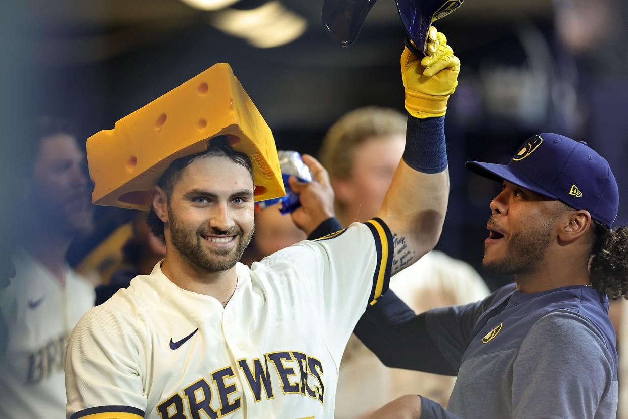 Garrett Mitchell celebrates a home run with a cheesehead against the New York Mets during the sixth inning at American Family Field on April 4, 2023.