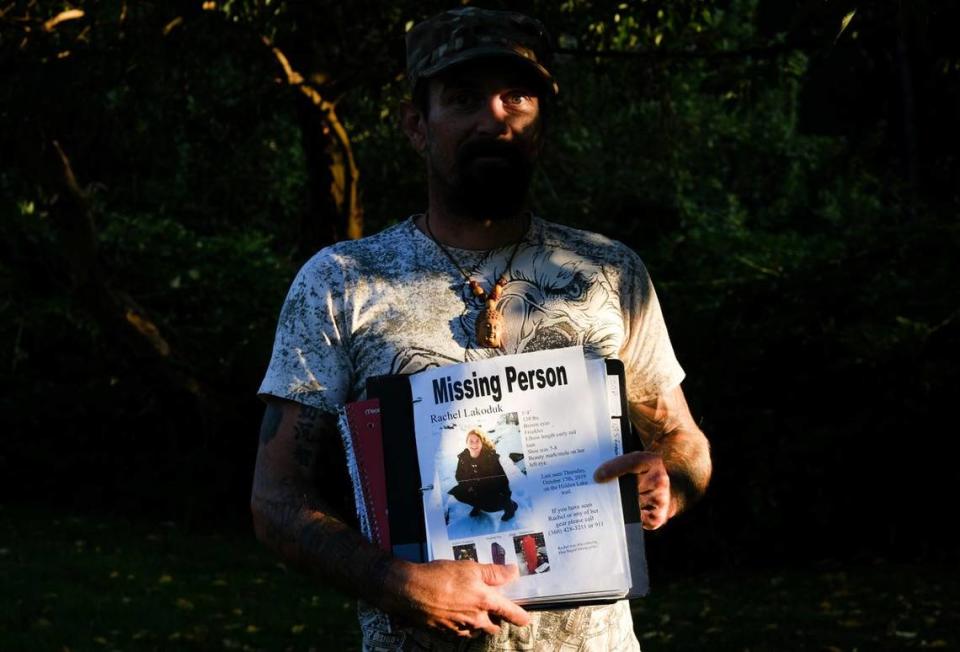 Carlton “Bud” Carr Jr. poses for a photo on Monday, Aug. 23, 2021, in the backyard of his home in Concrete, Wash. Carr is holding the file containing his search notes on Rachel Lakoduk, a 28-year-old Moses Lake hiker who went missing on Oct. 17, 2019, while attempting to reach Hidden Lake Lookout – a remote fire lookout in the Mt. Baker-Snoqualmie National Forest. Carr owns and operates 49th Parallel, a private search and rescue group, and spent at least 70 days searching for Rachel.