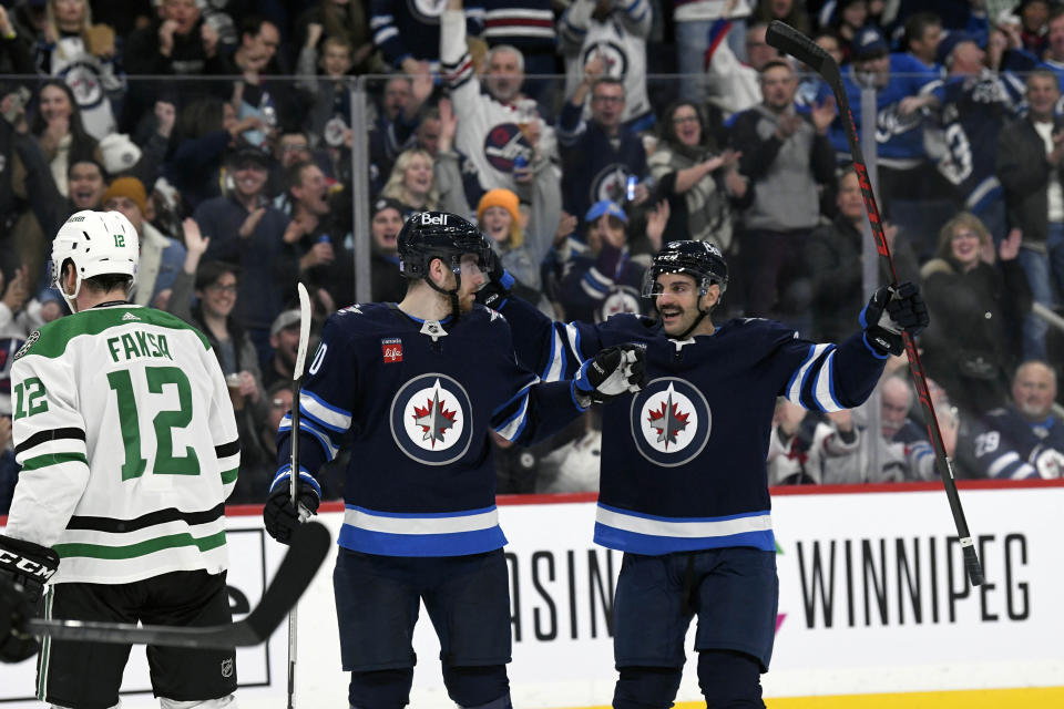 Winnipeg Jets' Pierre-Luc Dubois (80) celebrates his goal against the Dallas Stars with Dylan DeMelo (2) during the second period of an NHL hockey game, Tuesday, Nov. 8, 2022 in Winnipeg, Manitoba. (Fred Greenslade/The Canadian Press via AP)