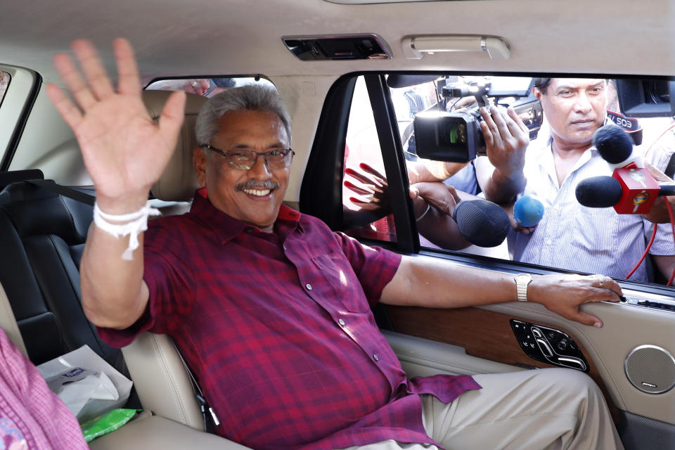 Sri Lanka's former Defense Secretary and presidential candidate Gotabaya Rajapaksa waves to the media after casting vote in Embuldeniya, on the outskirts of Colombo, Sri Lanka, Saturday, Nov. 16, 2019. Polls opened in Sri Lanka’s presidential election Saturday after weeks of campaigning that largely focused on national security and religious extremism in the backdrop of the deadly Islamic State-inspired suicide bomb attacks on Easter Sunday. (AP Photo/Eranga Jayawardena)