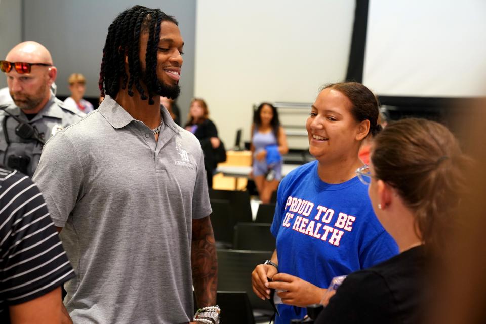 Buffalo Bills safety Damar Hamlin speaks with Ebonie Johnson following a hands-only CPR training event hosted by his Chasing M’s Foundation. Since his cardiac arrest on the field on Jan. 2, Hamlin has been advocating for CPR training.