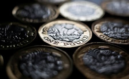 FILE PHOTO - Pound coins are seen in the photo illustration taken in Manchester, Britain September 6, 2017. REUTERS/Phil Noble/Illustration