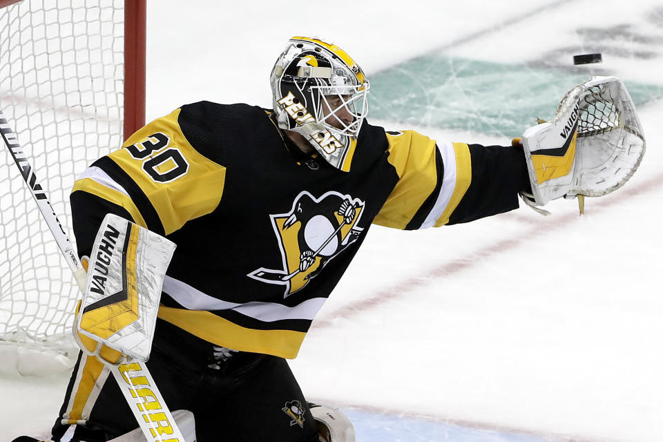 Pittsburgh Penguins goaltender Matt Murray reaches for a shot during the first period in Game 4 of the team's NHL first-round hockey playoff series against the New York Islanders in Pittsburgh, Tuesday, April 16, 2019. (AP Photo/Gene J. Puskar)