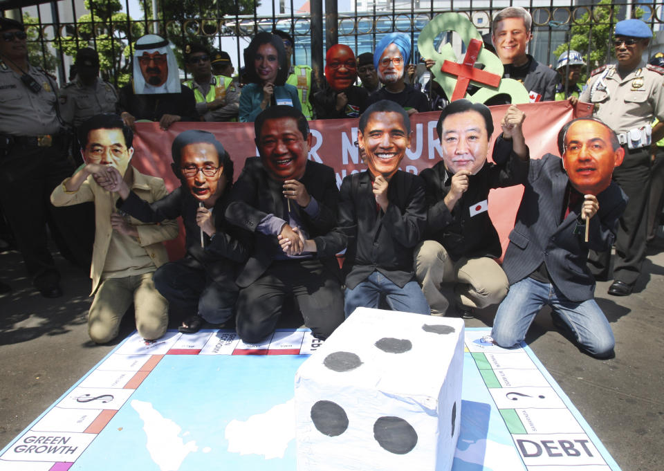 Protesters enact leaders of countries attending the Group of 20 summit meeting playing monopoly during a rally in Jakarta, Indonesia, Tuesday, June 19, 2012. The demonstrators criticized the economic policies implemented by the G20 leaders. (AP Photo/Achmad Ibrahim)