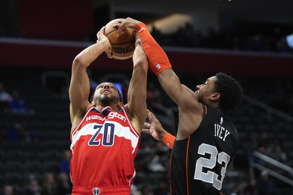 Washington Wizards guard Landry Shamet (20) drives on Detroit Pistons guard Jaden Ivey (23) in the second half of an NBA basketball game in Detroit, Saturday, Jan. 27, 2024. (AP Photo/Paul Sancya)