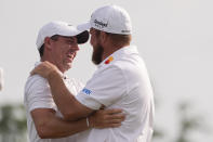 Shane Lowry, of Ireland, right, embraces his teammate Rory McIlroy, of Northern Ireland, after winning the PGA Zurich Classic golf tournament at TPC Louisiana in Avondale, La., Sunday, April 28, 2024. (AP Photo/Gerald Herbert)