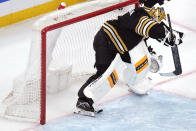 Boston Bruins goaltender Jeremy Swayman (1) looks for the puck, which nearly trickled over the goal line, during the first period of an NHL hockey game against the Carolina Hurricanes, Tuesday, April 9, 2024, in Boston. The play was initially called a goal, but was overturned by video review. (AP Photo/Charles Krupa)