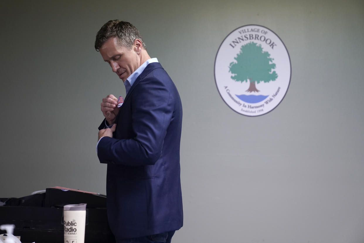 Former Missouri Gov. Eric Greitens applies an "I Voted" sticker after casting his ballot in Missouri's primary election Tuesday, Aug. 2, 2022, in Innsbrook, Mo. Greitens is running as a Republican for the U.S. Senate being vacated Sen. Roy Blunt, R-Mo., who is not seeking re-election. (AP Photo/Jeff Roberson)