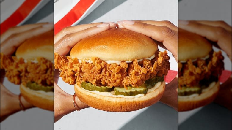 hands holding KFC chicken sandwich