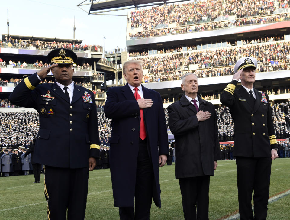 President Donald Trump, second from left, is joined by, from left, West Point Superintendent Lt. Gen. Darryl A. Williams, Defense Secretary Jim Mattis and Naval Academy Superintendent Vice Adm. Ted Carter, during the playing of the national anthem before the start of the Army-Navy NCAA college football game in Philadelphia, Saturday, Dec. 8, 2018. (AP Photo/Susan Walsh)