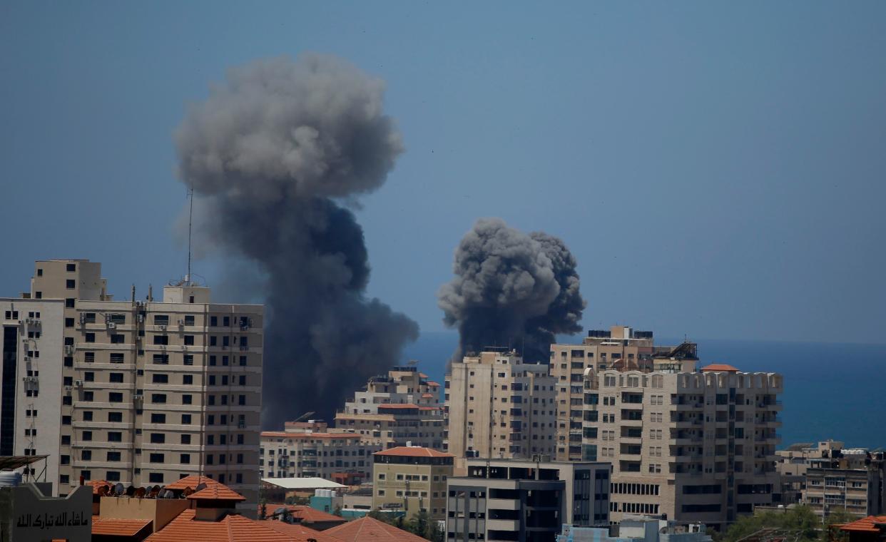 Smoke rises following Israeli airstrikes on a building in Gaza City on Thursday, May 13, 2021. Gaza residents are bracing for more devastation as militants fire one barrage of rockets after another and Israel carries out waves of airstrikes.