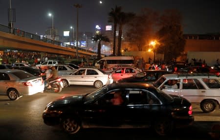 Small groups of protesters shouting anti-government slogans and run from tear gas fired by riot police near Tahrir Square in Cairo