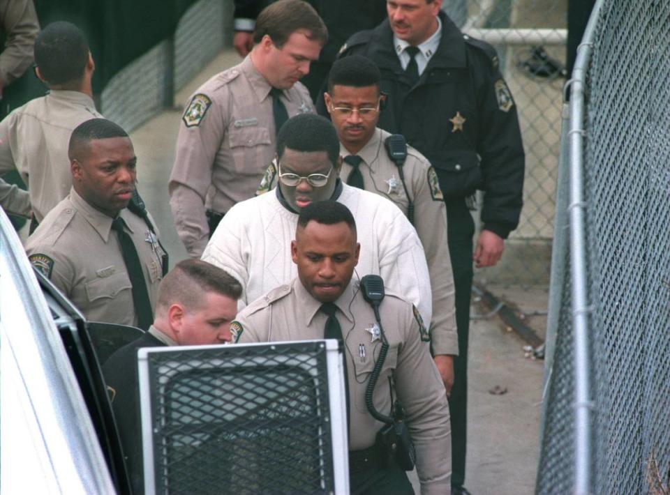 Deputies lead condemned serial killer Henry Louis Wallace to a van to transport him to Death Row in Raleigh on Wednesday, Jan. 29, 1997.