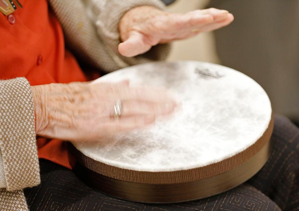 A senior plays a hand drum as music therapist Rachel Davis, of Sing Explore Create in Rockland, works with seniors at the Milton Senior Center, part of a new six-week music and wellness course called "Let's Make Music," on Wednesday, Oct. 5, 2022.