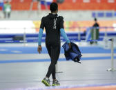 Shani Davis of the U.S. walks holding his jacket after competing in the men's speedskating team pursuit quarterfinals at the Adler Arena Skating Center during the 2014 Winter Olympics in Sochi, Russia, Friday, Feb. 21, 2014. (AP Photo/Matt Dunham)