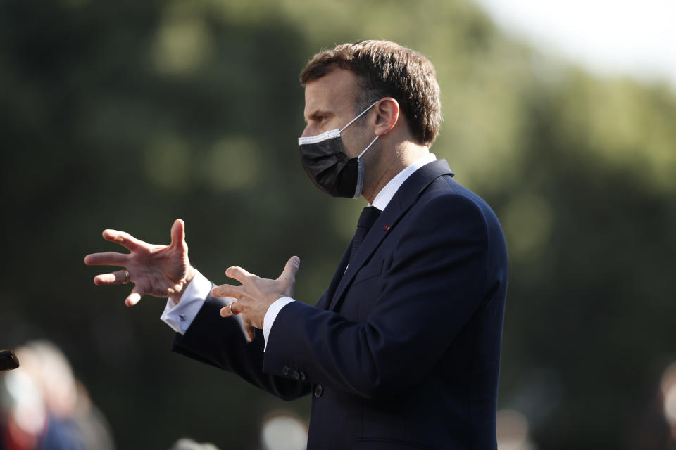 French President Emmanuel Macron speaks with the media as he arrives for an EU summit at the Crystal Palace in Porto, Portugal, Saturday, May 8, 2021. On Saturday, EU leaders hold an online summit with India's Prime Minister Narendra Modi, covering trade, climate change and help with India's COVID-19 surge. (AP Photo/Francisco Seco, Pool)