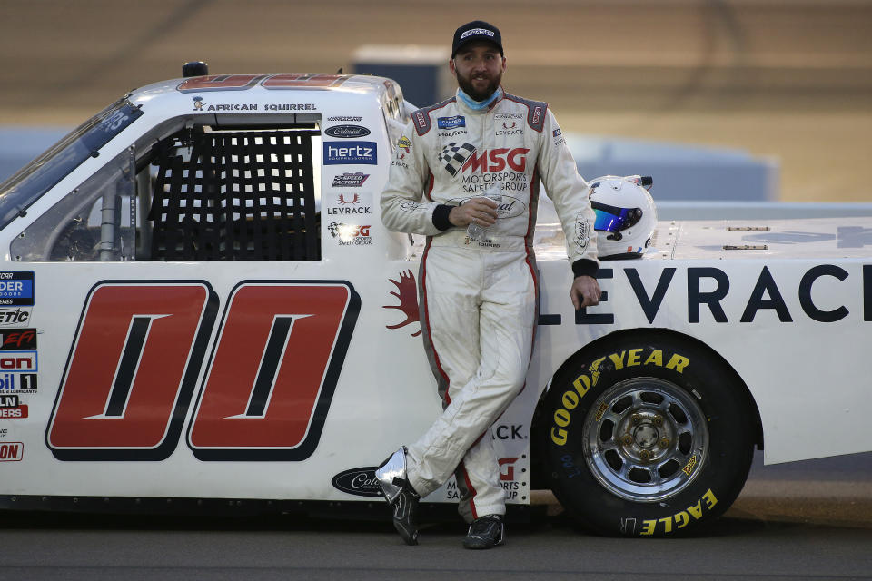 Josh Reaume stands with his race vehicle prior to the NASCAR Truck Series auto race at Phoenix Raceway, Friday, Nov. 6, 2020, in Avondale, Ariz. (AP Photo/Ralph Freso)