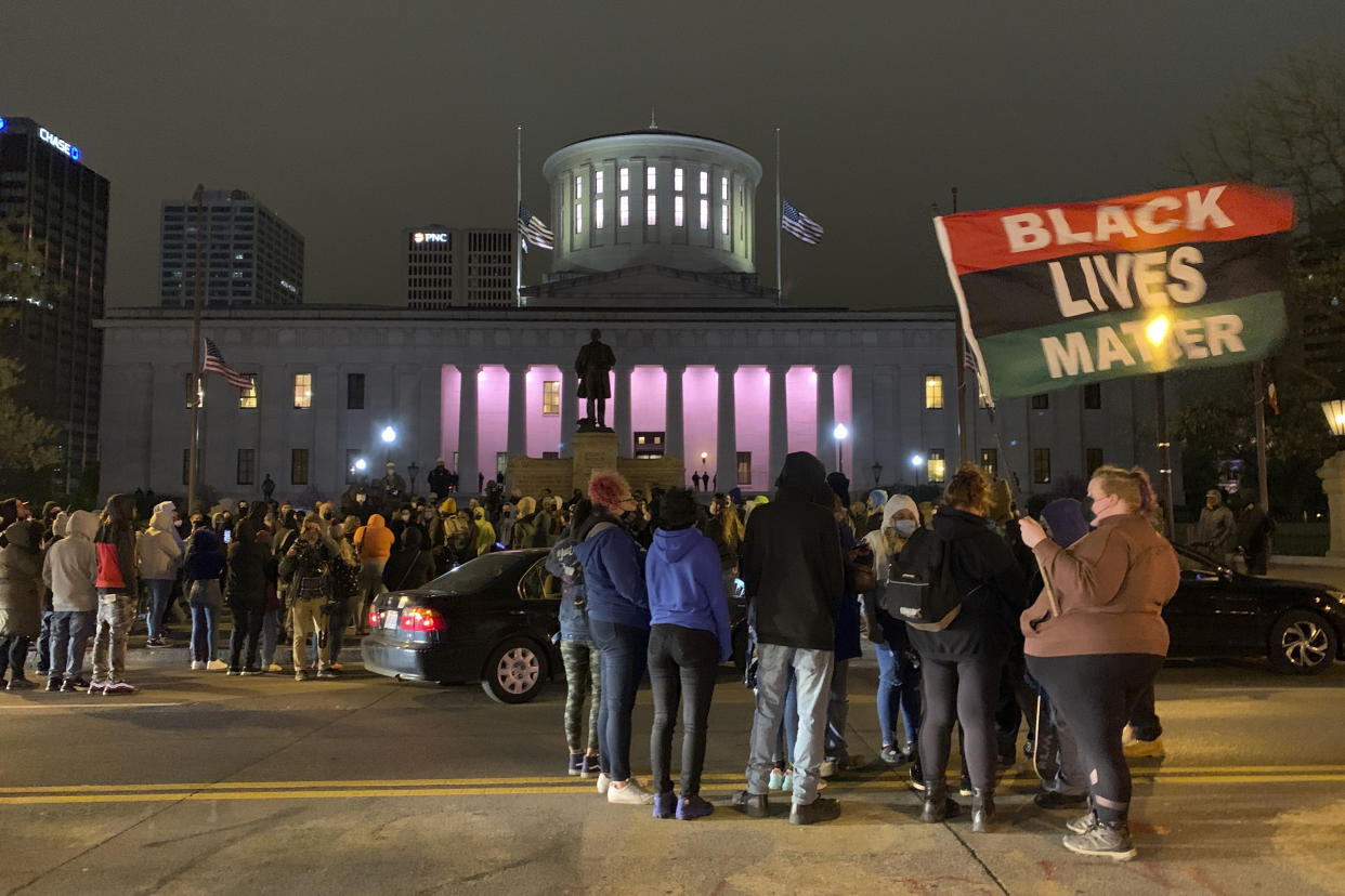A crowd gathers in front of the Ohio Statehouse during a  protest Tuesday, April 20, 2021, in Columbus, Ohio. Earlier Tuesday, police shot and killed a teenage girl in Columbus just as the verdict was being announced in the trial for the killing of George Floyd. Police showed bodycam footage Tuesday night at a news conference of the officer shooting the girl, who was Black, as she appeared to attempt to stab two people with a knife. (AP Photo/Jay LaPrete)