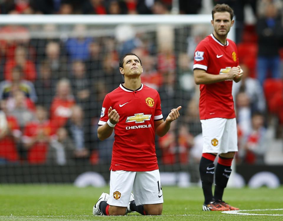 Manchester United's Hernandez prays before their English Premier League soccer match against Swansea City at Old Trafford in Manchester