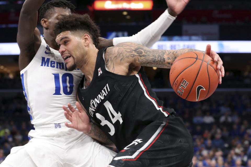 Memphis' guard Damion Baugh (10) defends Cincinnati's guard Jarron Cumberland (34) in the first half of an NCAA college basketball game Thursday, Jan. 16, 2020, in Memphis, Tenn. (AP Photo/Karen Pulfer Focht)