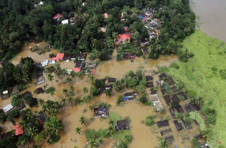 FILE PHOTO - An aerial view shows partially submerged houses at a flooded area in Kerala, August 17, 2018. REUTERS/Sivaram V