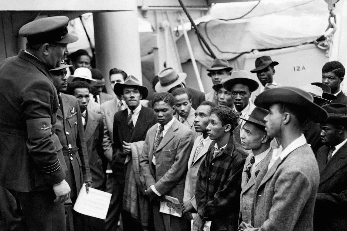 Jamaican immigrants welcomed by RAF officials from the Colonial Office after the ex-troopship HMT Empire Windrush landed at Tilbury (PA Wire)