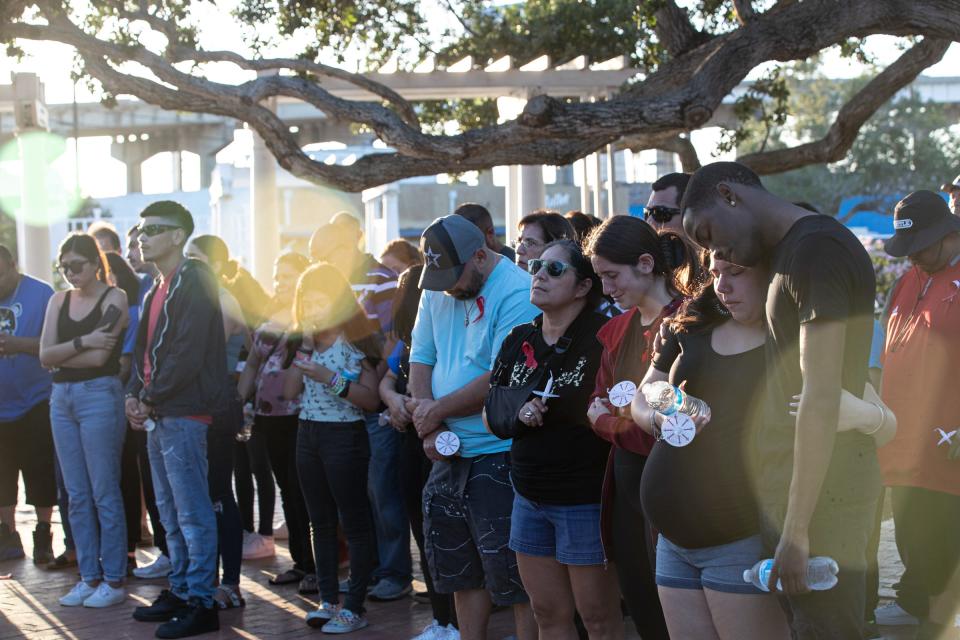 Mourners gather at Heritage Park during a candlelight vigil for Ray High School seniors Marcello Saldua and Matthew Garcia, on Thursday, June 2, 2022, in Corpus Christi, Texas. 