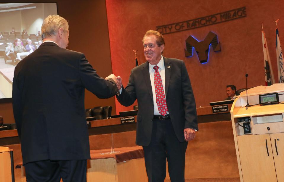 Steve Downs, left, and Richard Kite bump fists after being sworn in as the mayor pro tem and mayor, respectively, Thursday at Rancho Mirage City Hall.