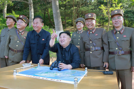 FILE PHOTO : North Korean leader Kim Jong Un inspects the intermediate-range ballistic missile Pukguksong-2's launch test with Kim Jong Sik (2nd L), Ri Pyong Chol (3rd L) and Jang Chang Ha (R) in this undated photo released by North Korea's Korean Central News Agency (KCNA) May 22, 2017. KCNA/via REUTERS/File Photo