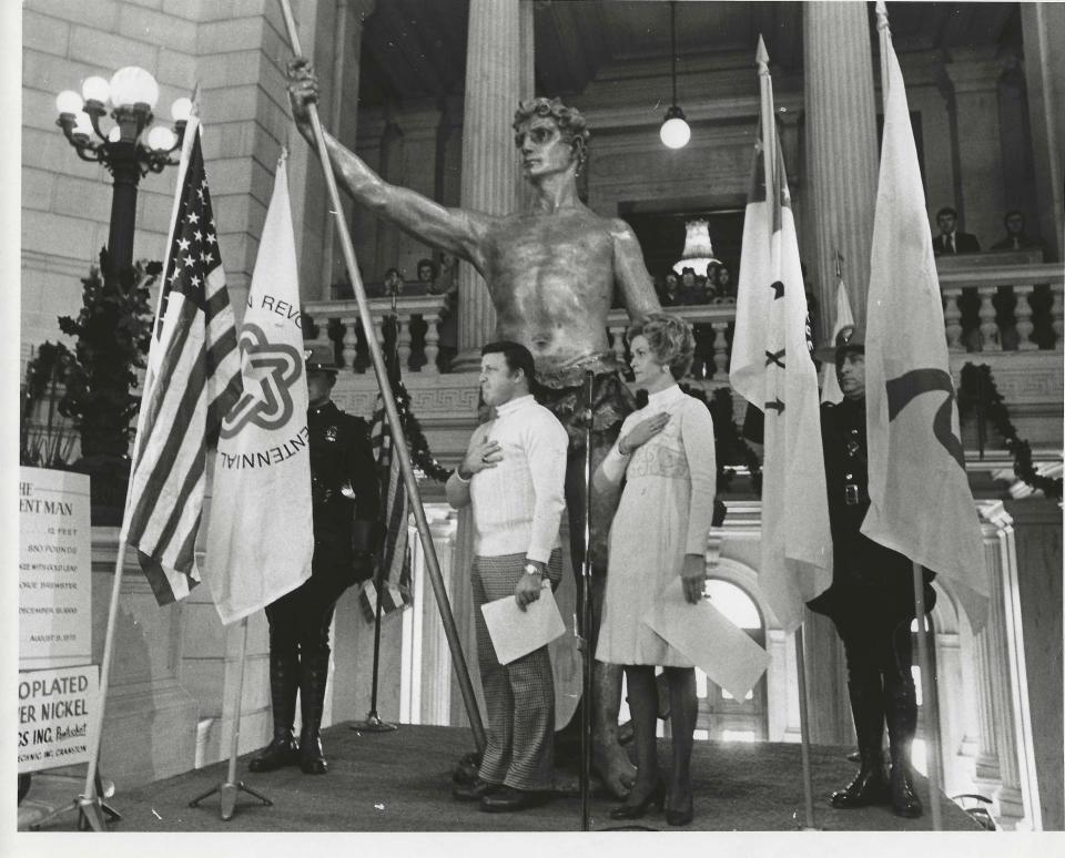 Ceremony moving the Independent Man from Warwick Mall (now Rhode Island Mall) to the State House rotunda in 1976.  Pat Conley, left, and Rhode Island First Lady Joyce Noel, right, presided at the event.