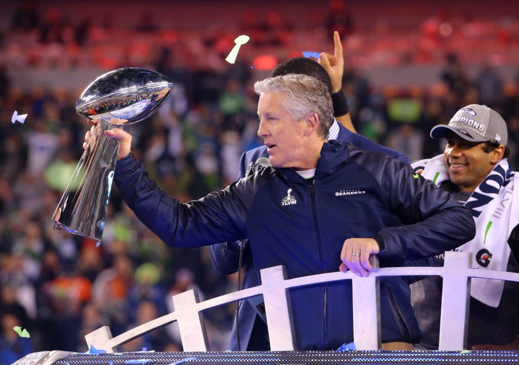 Feb 2, 2014; East Rutherford, NJ, USA; Seattle Seahawks head coach Pete Carroll celebrates with the Lombardi Trophy after beating the Denver Broncos 43-8 in Super Bowl XLVIII at MetLife Stadium. Mandatory Credit: Brad Penner-USA TODAY Sports