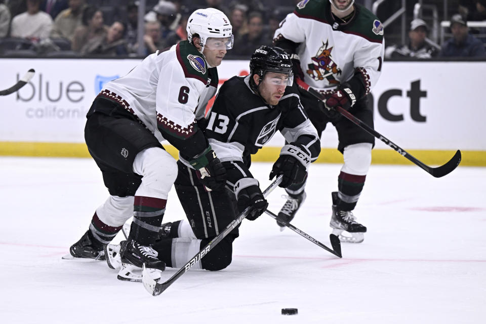 Los Angeles Kings right wing Gabriel Vilardi (13) tries to get a shot off with Arizona Coyotes defenseman Jakob Chychrun defending during the second period of an NHL hockey game in Los Angeles, Thursday, Dec. 1, 2022. (AP Photo/Alex Gallardo)