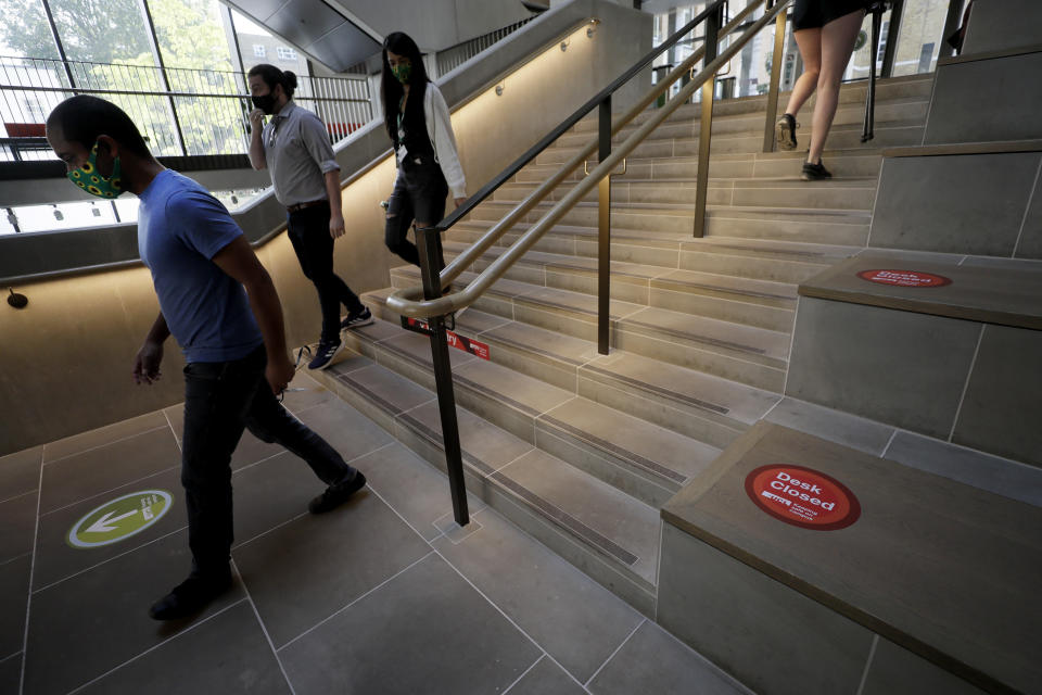 Arrows mark a one way walking system at UCL (University College London) in London, Thursday, Sept. 17, 2020. The university is preparing its return to campus COVID-19 measures. (AP Photo/Kirsty Wigglesworth)