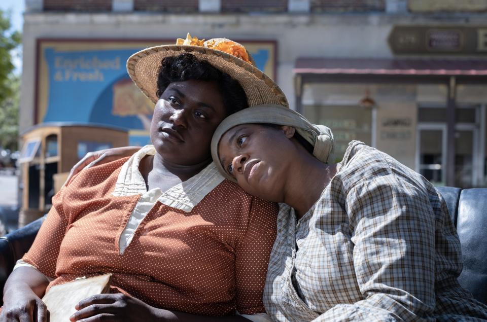 Danielle Brooks sits in a car as Fantasia leans on her shoulder in "The Color Purple."