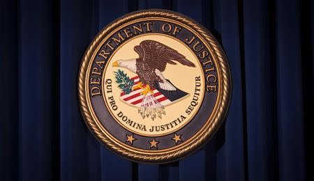 FILE PHOTO: The Department of Justice (DOJ) logo is pictured on a wall after a news conference in New York December 5, 2013. REUTERS/Carlo Allegri/File Photo