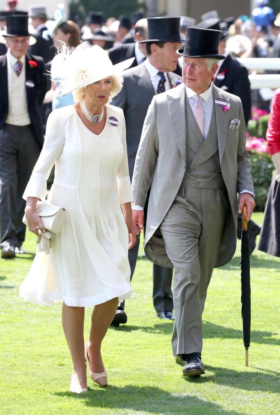 <p>Camilla, like Kate, chose an all-white look. But while Kate opted for a small hat, the Duchess of Cornwall made a splash with a wide-rimmed number. Meanwhile Prince Charles worked a grey three-piece suit, with pale pink tie, and black top hat. <br><em>[Photo: Getty]</em> </p>