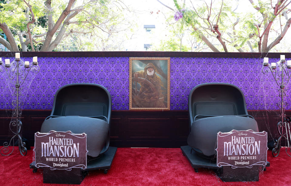 the red carpet has two large empty roller coaster chairs