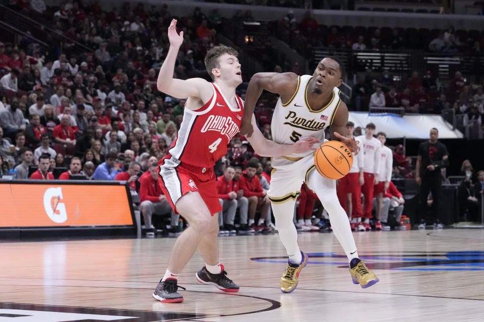 Purdue's Brandon Newman is defended by Ohio State's Sean McNeil (4) during the second half of an NCAA semifinal basketball game at the Big Ten men's tournament, Saturday, March 11, 2023, in Chicago. (AP Photo/Charles Rex Arbogast)