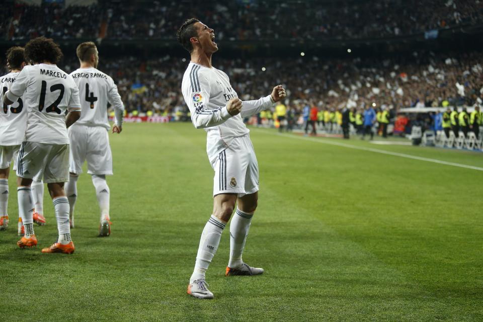 Real's Cristiano Ronaldo, centre, celebrates his goal during a Spanish La Liga soccer match between Real Madrid and FC Barcelona at the Santiago Bernabeu stadium in Madrid, Spain, Sunday, March 23, 2014. (AP Photo/Andres Kudacki)