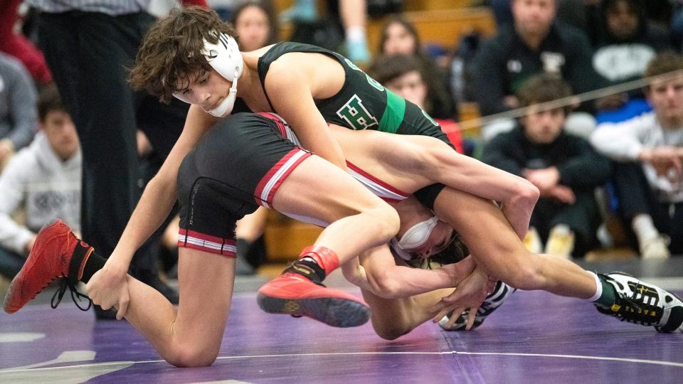Camden Catholic's Lazarus Joyce, top, defeated Haddonfield's Michael Lamb, 5-4, during a 106 lb. bout of the quarterfinal round of the Region 7 wrestling tournament at Cherry Hill East High School  on Friday, February 24, 2023.  