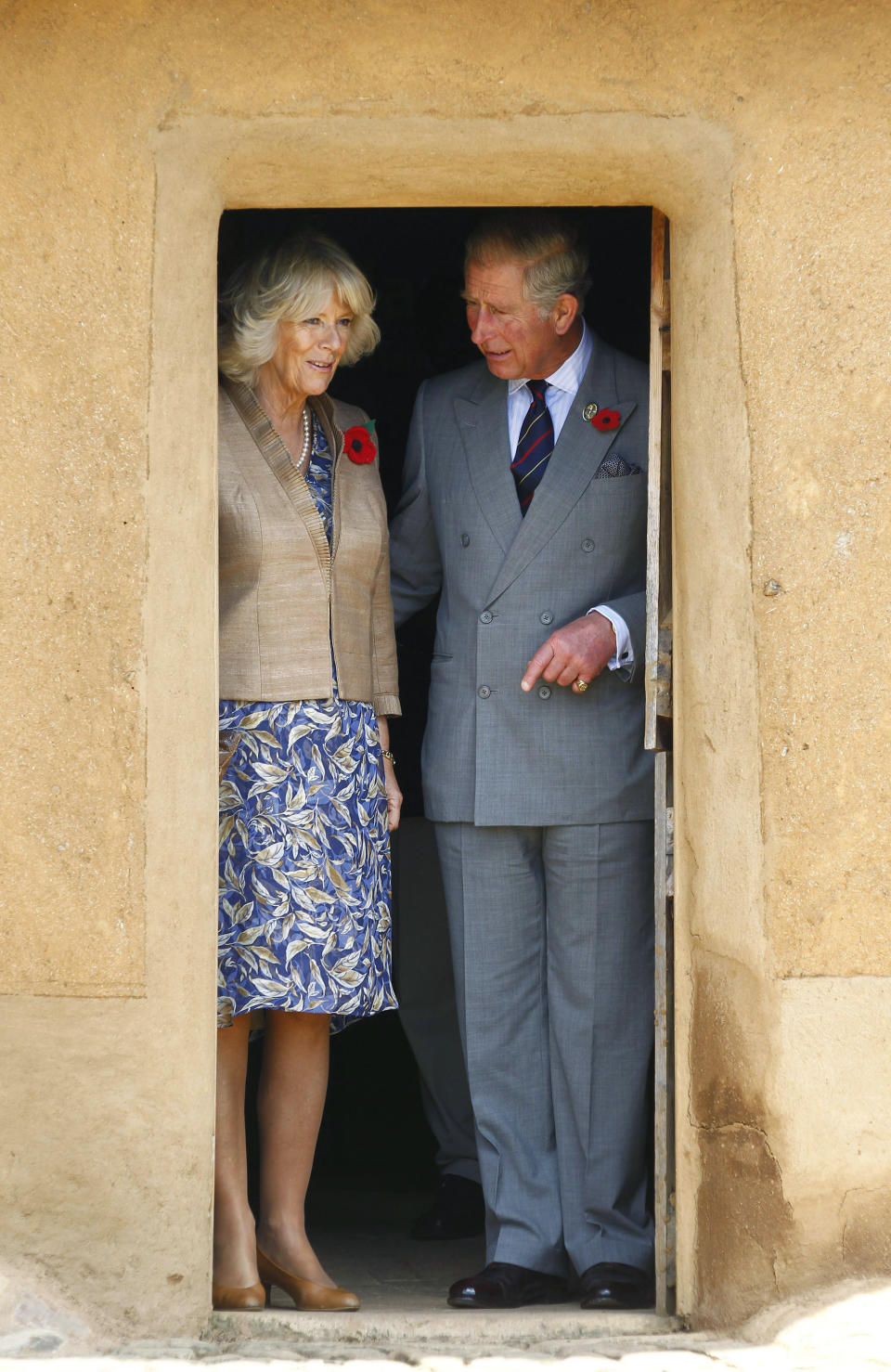 Britain's Prince Charles, left, and his wife Camilla, the Duchess of Cornwall stand in a traditional mud hut during a tour of Kirstenbosch National Botanical Garden in Cape Town, South Africa, Saturday, Nov. 5, 2011. (Mike Hutchings, Pool Photo via AP, File)